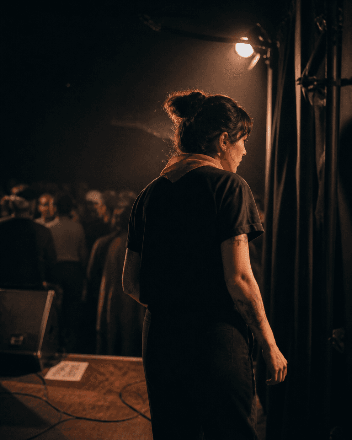 An independent musician preparing to enter a small venue