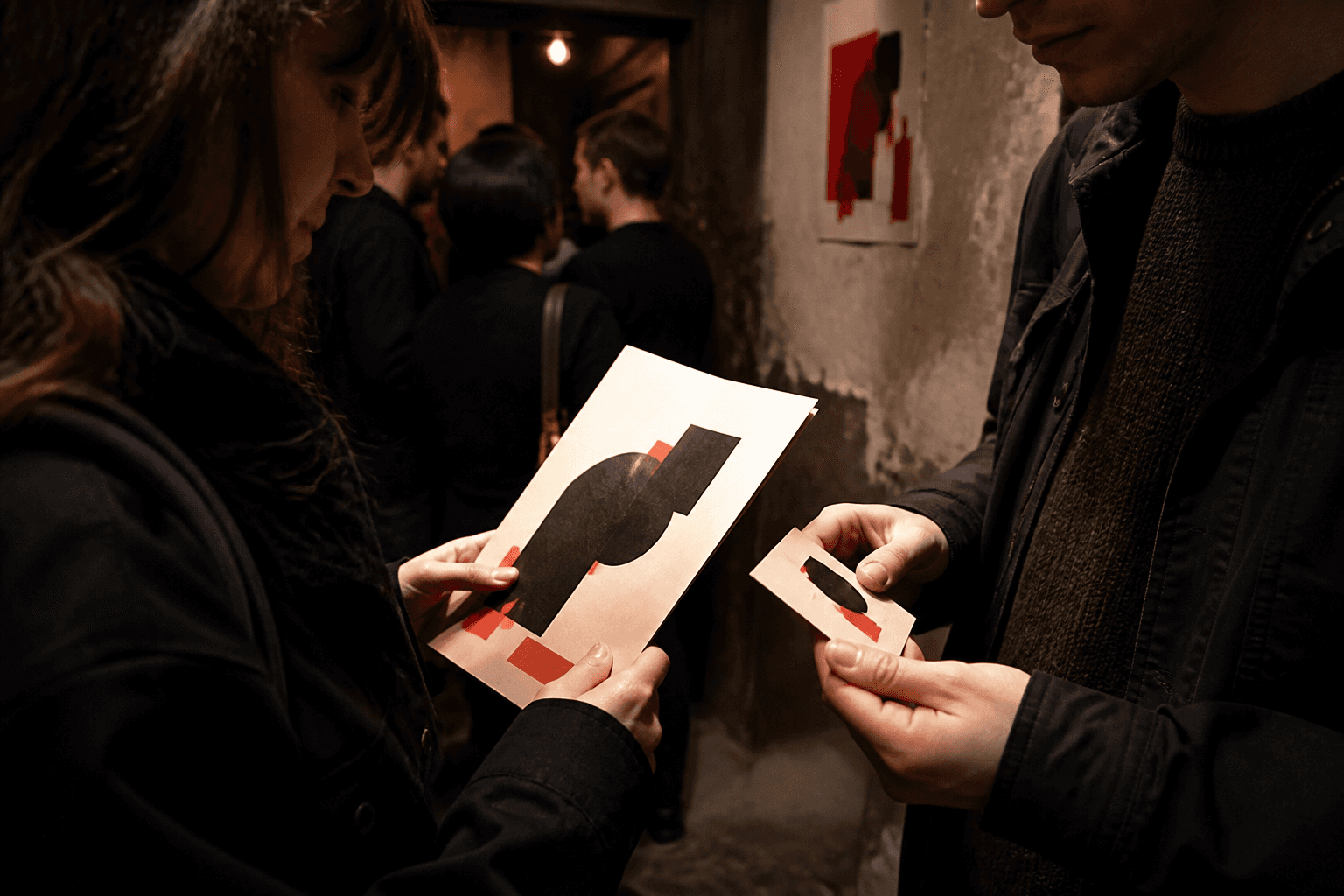 Supporters sharing a printed membership piece at an independent event